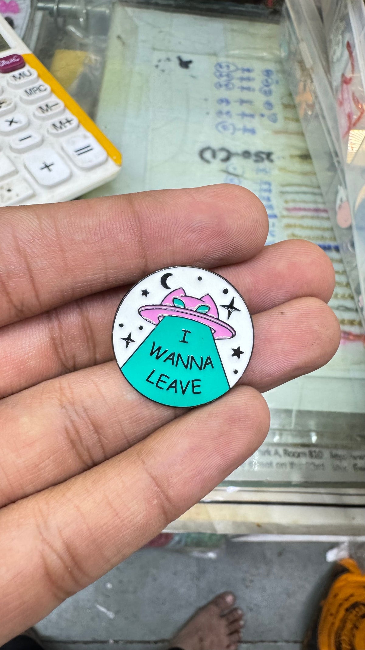 Century Fancy Beads enamel brooch pin featuring a pink UFO, cat, and the text I WANNA LEAVE on a white background