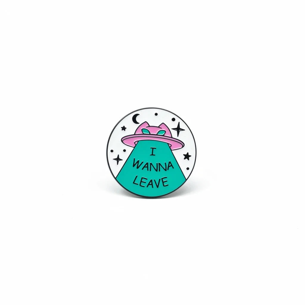 Century Fancy Beads round enamel brooch pin featuring a pink UFO and teal tractor beam with I WANNA LEAVE text